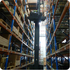 Reach stacker forklift in tall  warehouse